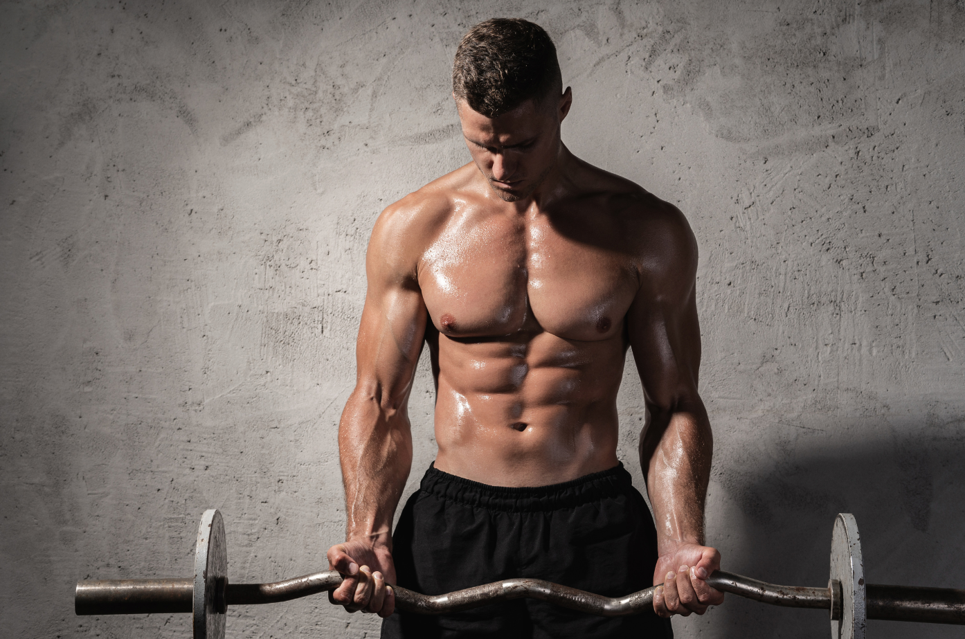 A man is holding a barbell in his hands